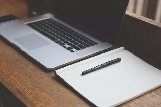 Computer and notebook on a desk