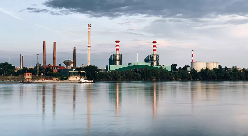 A picture of a power station as seen from across a river.