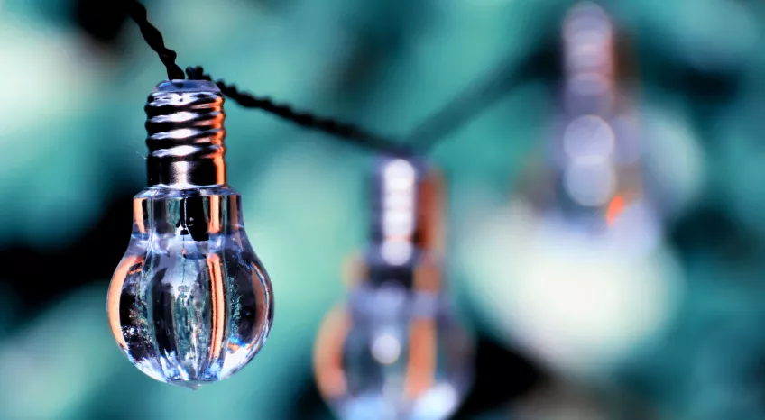 A close-up of solar-powered lightbulbs hanging from a string 