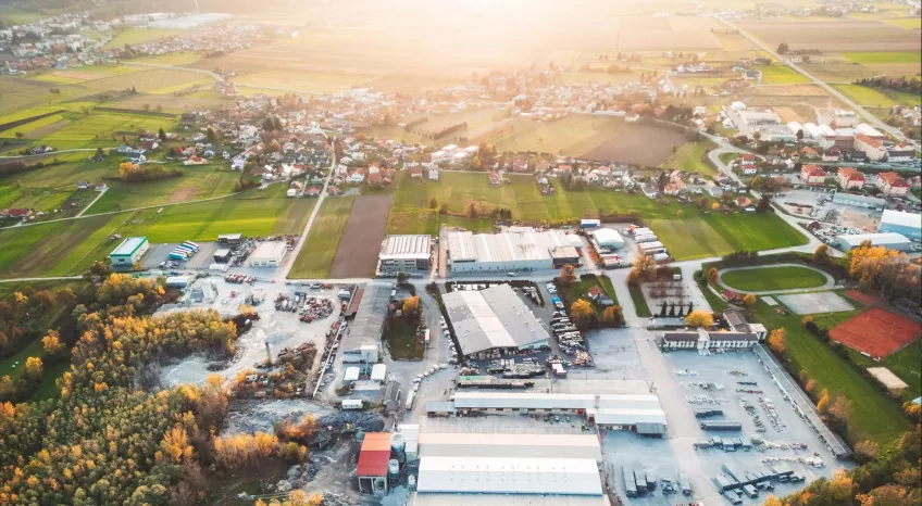 The sun is setting over an industrial area 